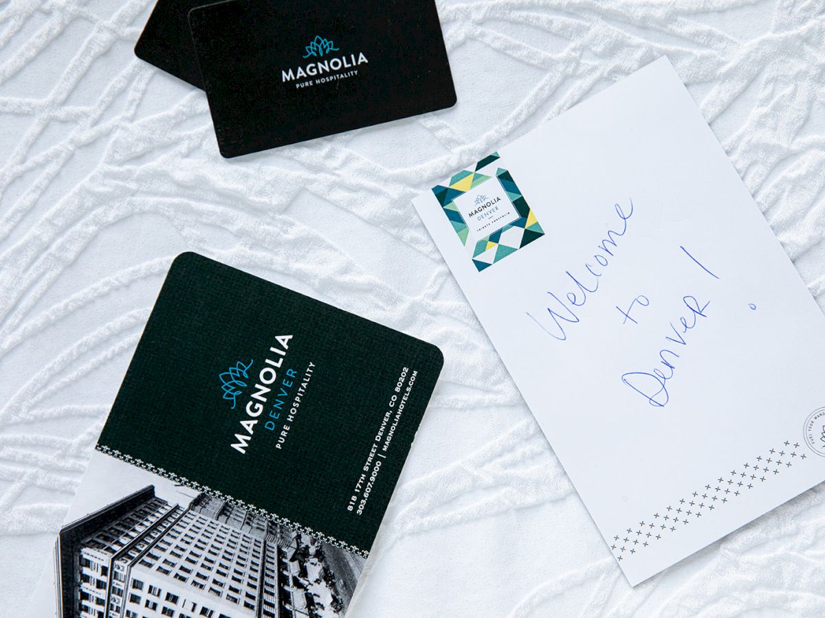 The image shows Magnolia hotel keycards and an envelope with 