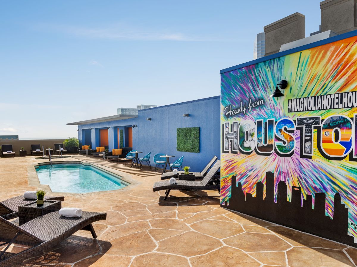 Rooftop pool area with mural saying 