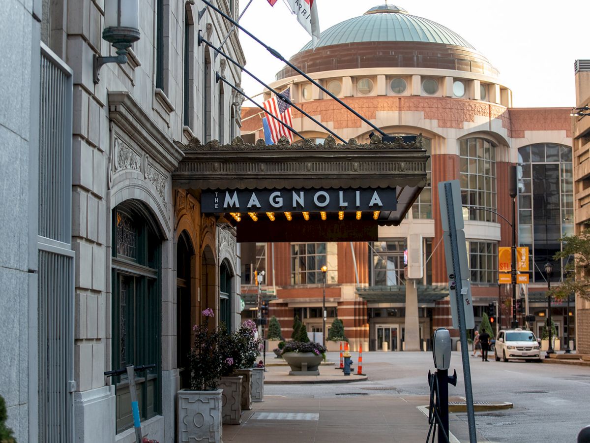 Street view with a building sign reading 