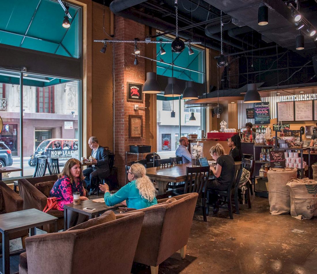 A coffee shop with people sitting at tables