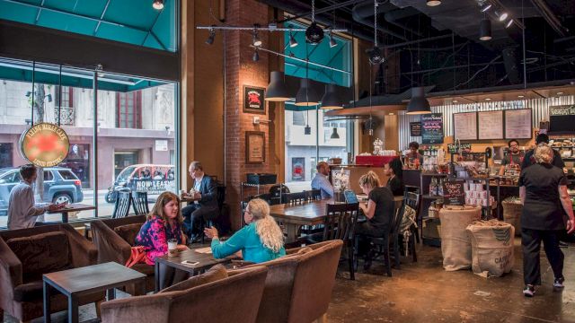 a coffee shop with people sitting at tables