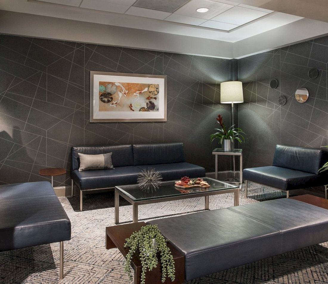 A hotel lobby with a seating area, artwork, and decorative elements.