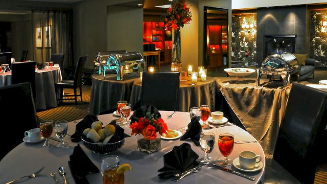 a formal dining room with round tables set for dinner