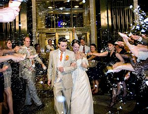 A wedding party walking through a hotel lobby