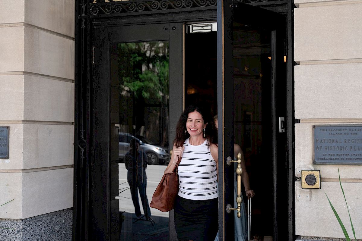 A person is exiting a building labeled 
