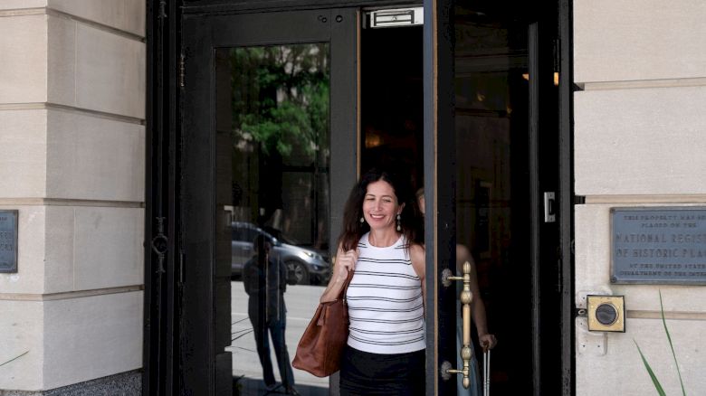 A person is exiting a building labeled 