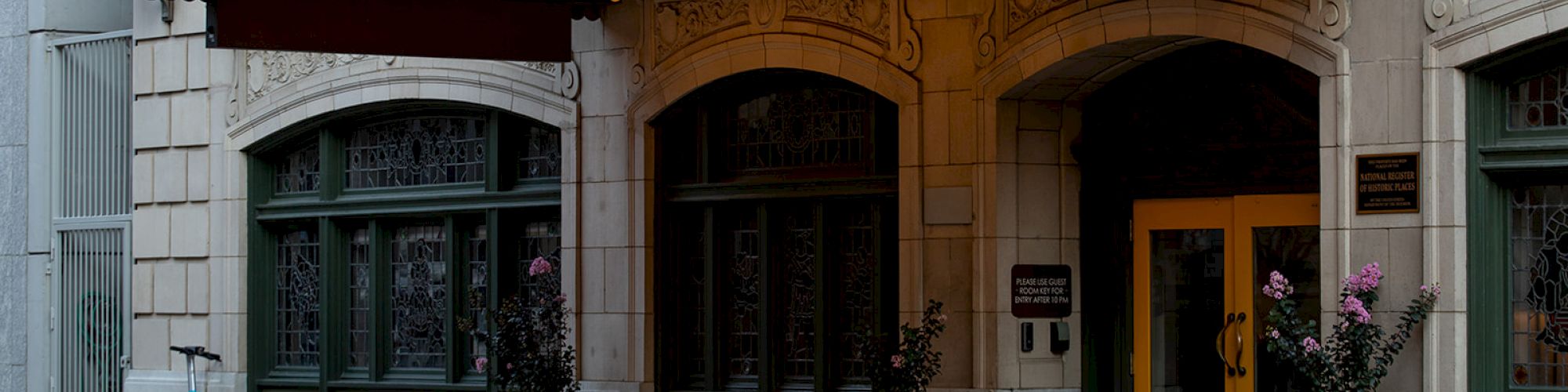 The image shows the entrance of a building with a sign reading 