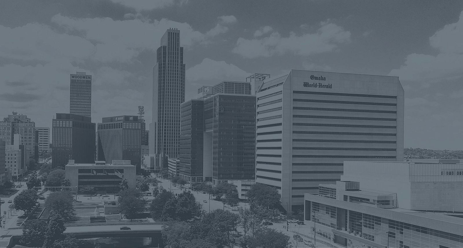 An urban skyline features several tall buildings, including one labeled